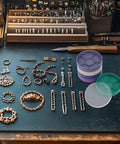 Round Watch Parts Tray With Stackable Layers And Portable Storage Case Built Tough With ABS on a jeweler's desk with tools and parts