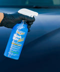 Hand holding Wet Or Waterless Wash Wax Kit 144oz UV Protection For Quick Spray On And Wipe Dry Shine bottle on vehicle surface