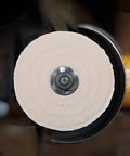 Two Pieces Of Versatile Cotton Polishing Buffing Wheels For Fast Bench Grinder Work That Delivers A Blinding Mirror Finish On Wood Metal And Stone Surfaces Every Single Time, showing a close-up of a beige cotton wheel.