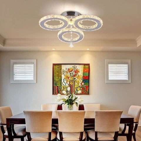 LED Crystal Pendant Ceiling Light With 3 Rings Cool Sleek Chandelier Flush Mount For Bedroom And Living Room above dining table.