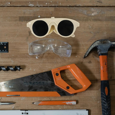 Built Tough Welding Glasses And Protective Goggles For Industrial Grinding, Super Comfy Ergonomic Fit, Straight Up 5 Pack Eye Safety Gear displayed on a workbench.