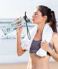 Woman at beach drinking from 32 Oz BPA Free Tritan Sports Water Bottle Built For Gym Grind, Hiking, Cycling And Fitness Junkies
