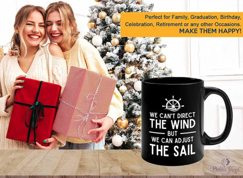 11 Oz Black Sailor Coffee Mug We Can Adjust The Sail Gift displayed on a table with holiday backdrop and smiling people holding gifts.