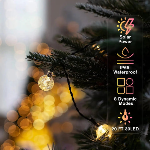 Solar String Lights For Outdoor 20Ft 30 LED Crystal Globe Fairy Lights Warm White illuminating a pine tree branch at night.