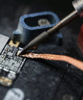 No Clean Solder Wick Desoldering Braid Set used for tin removal on circuit board, showcasing precision and effectiveness in solder removal.