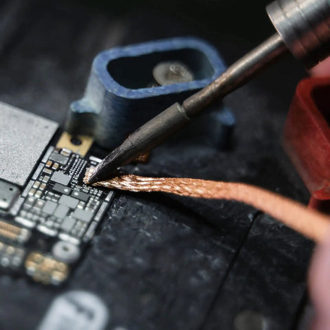 No Clean Solder Wick Desoldering Braid Set used for tin removal on circuit board, showcasing precision and effectiveness in solder removal.