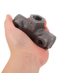 Hand holding Built Tough Cast Iron Air Compressor Four Way Manifold Block With One Half Inch And One Quarter Inch Female Threads