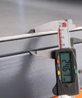 Close-up measurement of the 8mm thick steel plate on the Top Notch Polished Mold Maintenance Bench with 3000kg load rating.