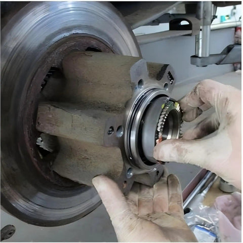 Hand installing hub nut using Ford 4 Lug Rear Axle Nut Socket Wrench For F Series Trucks Ten And A Half Inch Spindle Nut Size Two And Three Quarter Inch Outer Heavy Duty Hub Nut Tool For Quick DIY Removal And Installation On F 250 And F 350 Models