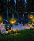 8 Pack Solar Tiki Torch Lights With Realistic Flickering Flame For Outdoor Garden Decor Waterproof LED Pathway And Patio Yard Lights That Charge In Sun Weatherproof And Easy To Install illuminating a patio at night