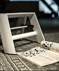 Lucano 1 Step White Folding Step Ladder With Integrated Grip Grooves And Safety Bar For Easy Folding Forward Design shown open on floor