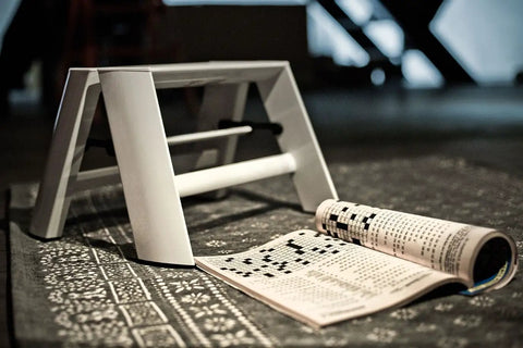 Lucano 1 Step White Folding Step Ladder With Integrated Grip Grooves And Safety Bar For Easy Folding Forward Design shown open on floor