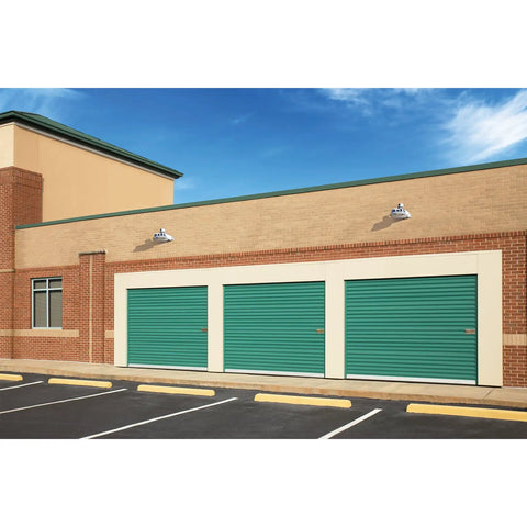 LED Dusk To Dawn Outdoor Area Light With 7100 Lumens And 4000K Glow installed above garage doors for nighttime security lighting