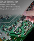 Hand using Ultimate 80W Soldering Iron Kit With Solder Sucker Tweezers Stand Holder Wire Cutter Tips And Cleaner