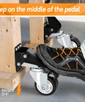 Person stepping on pedal of Heavy Duty Retractable Caster Wheels Set Of 4 For Workbench And Machinery Benches 880 Lb Capacity