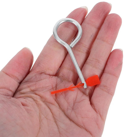 30 Pack Fire Extinguisher Replacement Seals With Tamper Proof Security Pins in a hand, showcasing the silver pin with orange tag.
