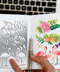 Heavy Duty Metal Flamingo And Butterfly Cutting Template Four By Seven Inches in use with floral designs and pen