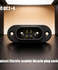 Close-up of Electric Scooter Charging Connector Socket With Copper Pin Power Port And Insulated Housing, front view