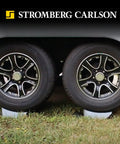 Base Pad Leveler Wheel Chock Set For RV And Trailer Leveling Blocks in use beneath trailer wheels for stability.