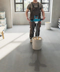 Person using Beefy 2100W Electric Cement Mixer Handheld Portable Concrete And Mortar Mixer in workshop with buckets of paint.