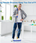 Man holding Extendable Floor Scrub Brush 12 Inch Wide Heavy Duty Grime Busting Two In One Scrub And Squeegee Deck Brush in kitchen