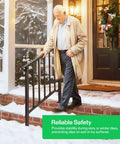 Heavy Duty Three Step Wrought Iron Handrail With Curved Metal Balusters In Matte Black Finish perfect for outdoor deck stairs with a person using it in winter.