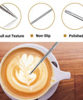 Stainless Steel Milk Frothing Pitcher 12oz 350ml With V Sharp Mouth For Latte Art Barista Ready Milk Jug Cup For Cappuccino Latte Macchiato Pro Grade Pouring Rust Proof Easy Clean Decorating Pen Included shown with a latte art pen above a cappuccino.