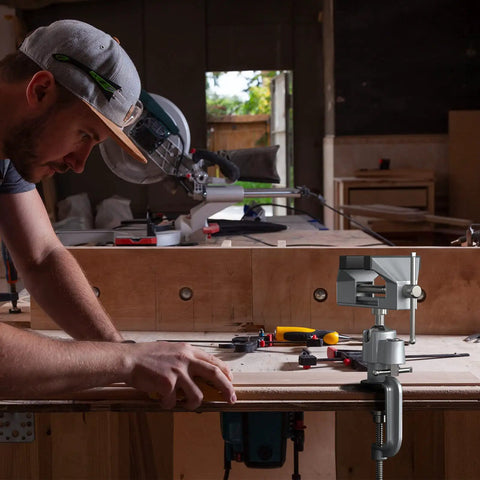 Man working with Two In One Universal Rotate 360 Degree Clamp On Vise With Drill And Grinder Holder in a woodworking shop.