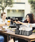 Group at outdoor table with Countertop Paper Plate Organizer With 6 Compartments And Silverware Caddy, holding cups and utensils.