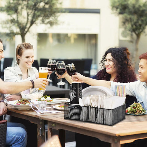 Group at outdoor table with Countertop Paper Plate Organizer With 6 Compartments And Silverware Caddy, holding cups and utensils.