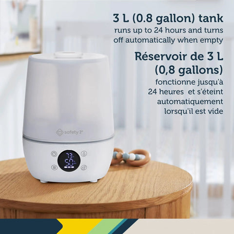 White filter free humidifier with auto humidity control and hygrometer on wooden table, digital display showing humidity level.