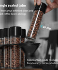 Single Dose Coffee Storage Tubes With One Way Exhaust Valve 8 Piece Set Espresso Dosing Jars And Walnut Holder showing sealed tube holding coffee beans.
