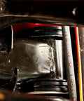 Close-up view of Delrin Rear Cradle Bushing Kit Boasting Zinc Coated Sleeves installed in chassis for enhanced handling.