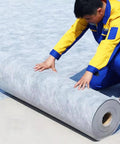 The Real Deal Gray Waterproof Membrane For Indoor Outdoor Floors Packs A Beefy 39 Mil Shield being unrolled for installation.