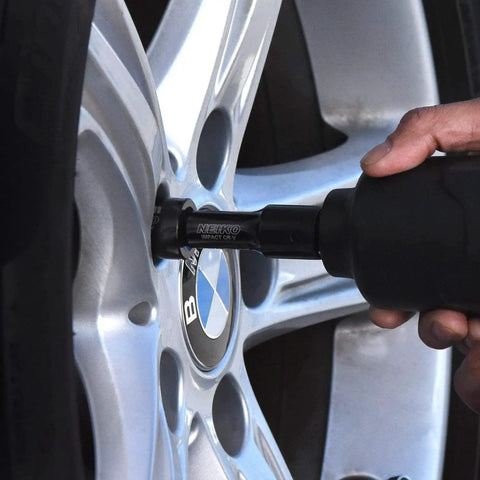 Master Impact Socket Set for Three Eighths Inch and One Half Inch Drives in use on car wheel lug nut