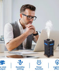 Man using DIY Humidifier Soldering Kit With Time And Humidity Settings OLED Display And LED Light Modes on desk