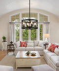 Dope Modern Farmhouse Black Drum Chandelier Light Fixture hanging in living room with sofas and coffee table