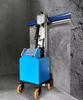 Full Auto Plastering Machine Cement Render Rig Wall Polisher For Construction Sites And Home Reno Boss Level Finish Smooth Operator Drywall Workhorse Tool on wheels, standing beside textured wall.