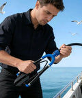 Man using Outboard Motor Flusher Kit With U Shape Inlet Muff And Anti Freeze Hose for marine craft maintenance.