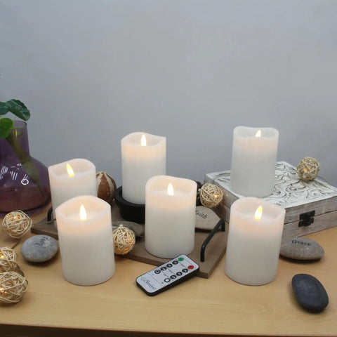 Six Count Real White Wax Flameless LED Pillar Candles 3 By 4 Inches With Remote And Timer on wooden shelf