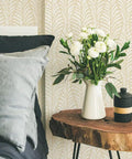 Removable Peel And Stick Wallpaper With Beige Block Print Leaves On Off White in bedroom, boho style with wooden table and flowers.