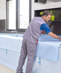 Man applying Temporary Floor Protection Roll 36 Inch By 100 Foot Anti Slip Surface Easy To Apply Paint Proof Reusable Durable Material
