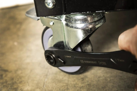 Person using Two Piece X6 Four In One Black Oxide Spline Ratcheting Metric Wrench Set For Tight Access And Maximum Versatility on wheel