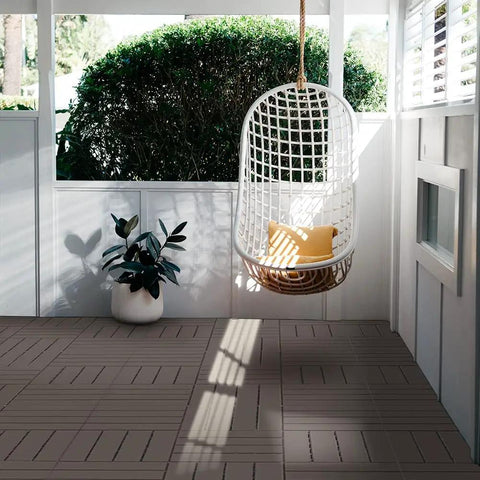 Interlocking Patio Deck Tiles 12x12 Inch Square Composite Plastic Outdoor Flooring in a porch with a hanging chair and plant