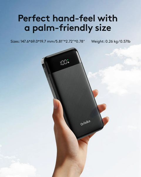 Rugged Portable Power Bank Delivering 22.5W Fast Charging Through Four Built In Cables For Plug And Play Convenience Ideal For Weekend Warriors Seeking A Reliable Quick Charge Fix On The Road Always in hand against a blue sky.