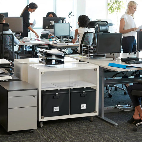 Office setting with desks and Heavy Duty Fireproof Document Box With Handle Portable Waterproof File Organizer for Papers visible.