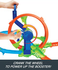 Close-up of hands operating cranked wheel booster on Launch And Loop Toy Car Track Set With Cranked Wheel Booster And Figure Eight Crash Zone.