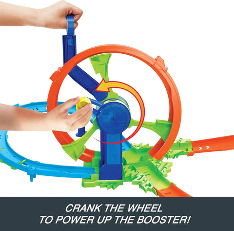 Close-up of hands operating cranked wheel booster on Launch And Loop Toy Car Track Set With Cranked Wheel Booster And Figure Eight Crash Zone.