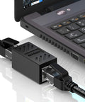 2 Pack Gigabit RJ45 In-Line Ethernet Couplers Female To Female Extender Adapters For Cat5e To Cat8 Cabling connected to a laptop