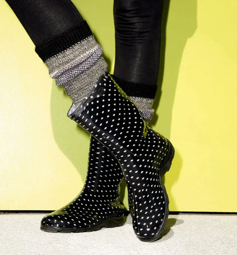 Women Mid Calf Waterproof Garden Rain Boots With Killer Traction And Legit All Day Comfy Support Insole For Yard Work Or Rainy Days Snazzy Black And White Polka Dot Style Made Stateside True To Size, shown with cozy socks.